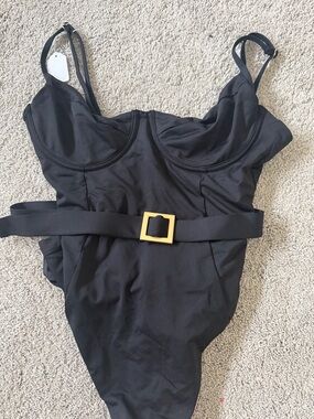 Brand New- never worn We wore what belted black one piece swimsuit